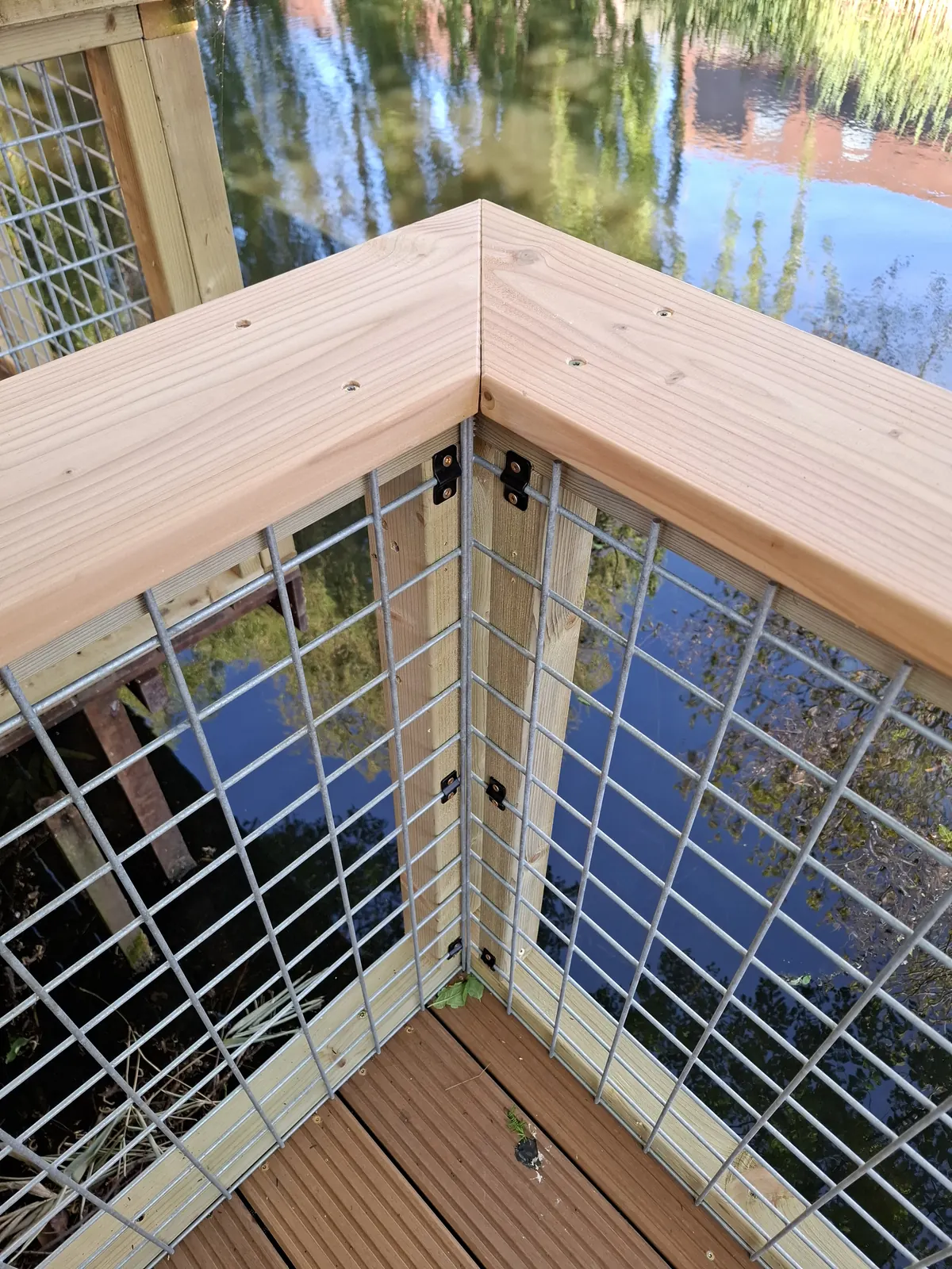 Hoekdetail van een balustrade met gaas en afdekplank